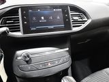 the interior of a car with a touch screen and steering controls