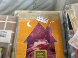 a box with a book on top of it next to a pillow