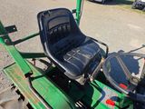 an image of a green tractor parked in a parking lot