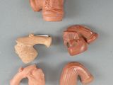 four pieces of clay figurines of different shapes and sizes