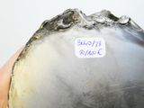 a close up of a silver vase with a sticker on it
