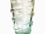 a clear glass cup with a handle on a white background