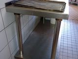 a stainless steel table with a sheet of paper on top of it