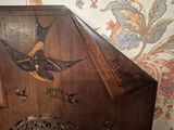 a bird painted on the side of a wooden piano