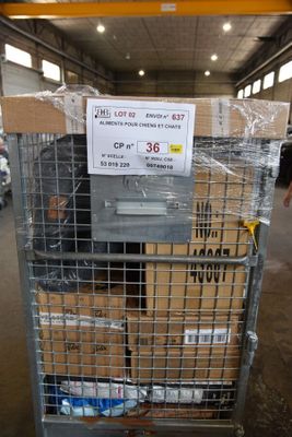 a cart with boxes and a sign on it in a warehouse