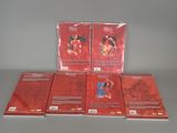 six red cards are stacked on top of each other on a table