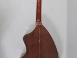 an image of a guitar hanging on a wall in a room