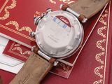 a watch sitting on top of a book with a leather strap