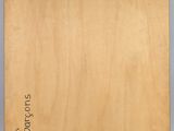a close up of a wooden plaque with a name on it