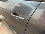 a close up of a car door handle with a hole in it