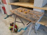a workbench with tools on top of it in a room