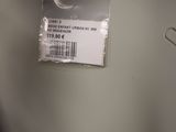 a plastic bag with a tag on it hanging on a wall