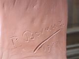 a statue of a foot with a hand on it