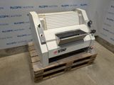 the machine is sitting on a pallet in front of a wall