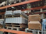 a large amount of wood stacked on pallets in a warehouse