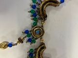 an image of a close up of a necklace on a white surface