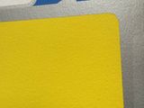a close up of a piece of paper with a yellow tag on it