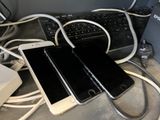 two cell phones that are connected to a laptop