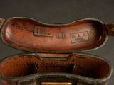 a brown leather case that has writing on the inside of it