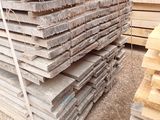 a pile of wood that is stacked up on the ground