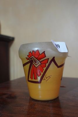 a yellow vase with a red bow on it sitting on a table