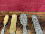 three brushes and a brush sitting on top of a wooden table
