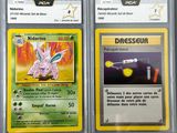 two pokemon cards with different designs on them on a table