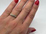 woman ' s hand with red manicured nails and a diamond ring