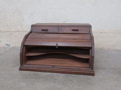 a small wooden desk with a drawer on top of it