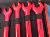 five red wrenches in a black case on a table