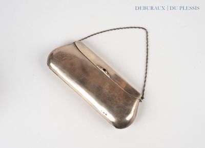 a silver purse that is sitting on a white surface