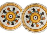 pair of yellow and white plates with flowers and leaves on them