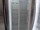 two refrigerators that are open in the kitchen