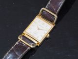 a watch that is sitting on a black surface