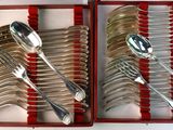 two sets of spoons and forks in a red box