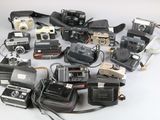 a lot of cameras that are sitting on a table