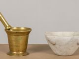 a mortar and a bowl sitting on a table