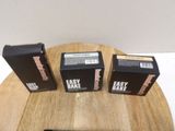 three boxes on a table with a remote on it