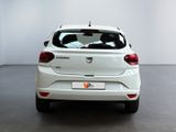 the rear end of a white car in a white room