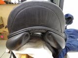 an image of a black leather saddle on a chair