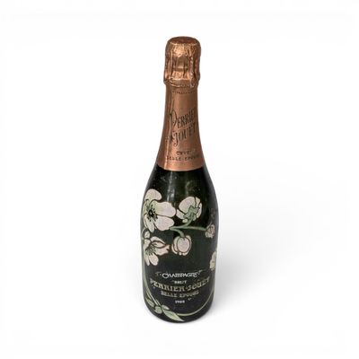 a bottle of champagne with white flowers on a white background