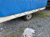 a blue tarp on the back of a boat