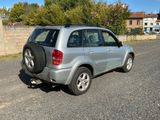 a silver suv that is parked on the side of the road