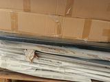 a stack of newspapers sitting on a pallet in a warehouse