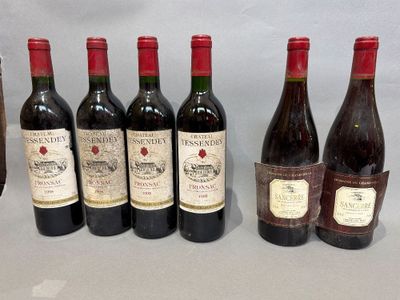 several bottles of wine are lined up on a table