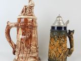 two beer mugs sitting next to each other on a table