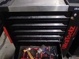 a tool drawer with tools inside of it in a garage