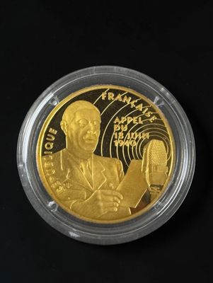 a close up of a gold coin with a man holding a microphone