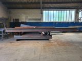 many pieces of steel sitting in a large warehouse