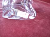 a glass figurine of a horse with a tag on it